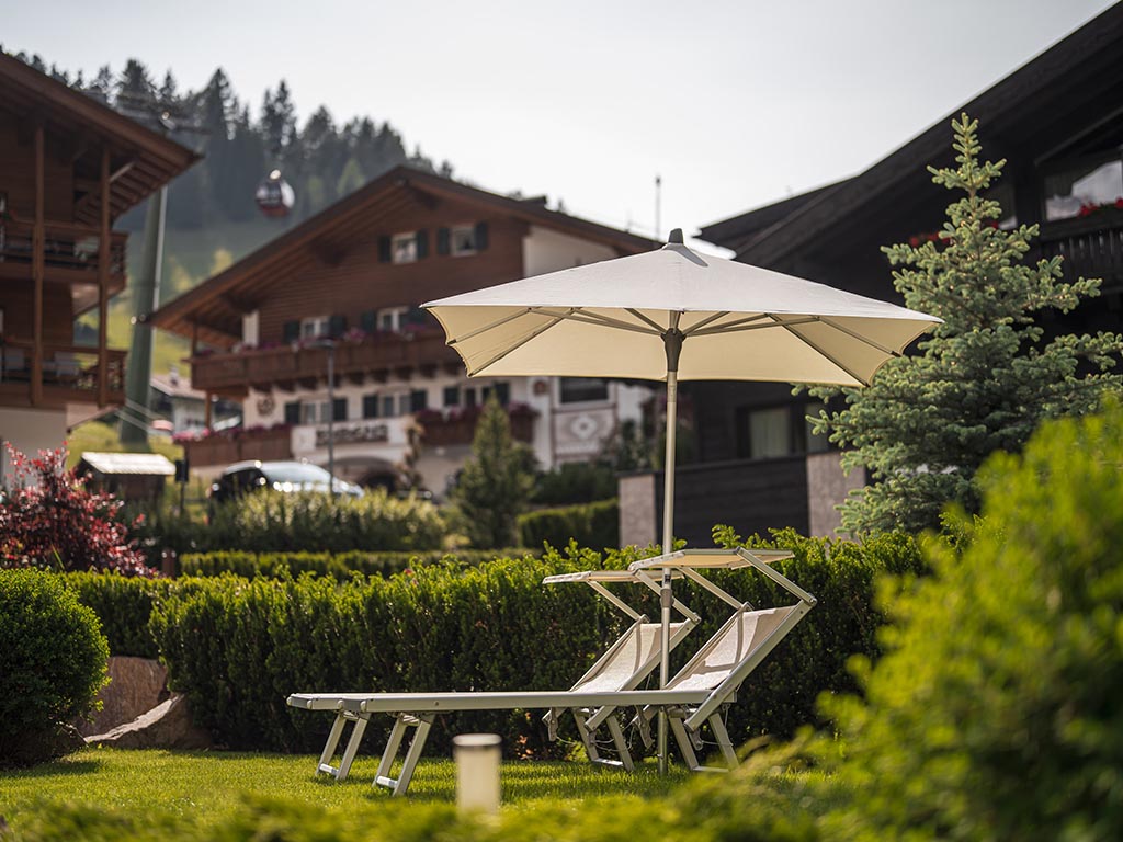 Our garden with sun loungers, umbrellas and pergola