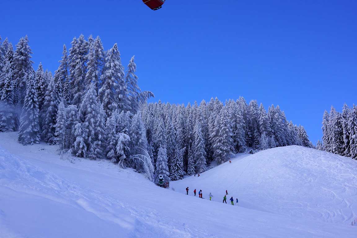Ski slope Freina in front of the Garni Hotel Arya Alpine Lodge in winter